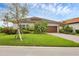 Charming single-story home with a well-manicured lawn, mature landscaping, and a two-car garage on a sunny day at 4524 Baltry Ct, Bradenton, FL 34211