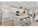 Modern kitchen with white cabinets, granite countertops, stainless steel appliances, and a breakfast bar at 4524 Baltry Ct, Bradenton, FL 34211