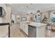 A spacious kitchen with a large island, stainless steel appliances, and a view of the living room at 4524 Baltry Ct, Bradenton, FL 34211