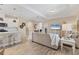 Spacious living room with kitchen, wood-look tile flooring, neutral paint, and modern furnishings at 4524 Baltry Ct, Bradenton, FL 34211