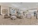 Bright open-concept living room and kitchen area with wood-look tile flooring and neutral paint at 4524 Baltry Ct, Bradenton, FL 34211