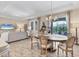 Open-plan living and dining room area features a chandelier, modern furnishings, and view of the pool at 4524 Baltry Ct, Bradenton, FL 34211
