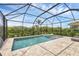 Backyard screened in pool with a spa and brick patio surrounded by lush landscaping at 4524 Baltry Ct, Bradenton, FL 34211