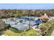 A full aerial view of the tennis courts showcases the multiple well-maintained courts and a covered gazebo at 4524 Baltry Ct, Bradenton, FL 34211