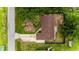 Aerial view of a cozy home featuring a brown roof, surrounded by lush greenery and a concrete driveway at 4616 34Th E Ave, Bradenton, FL 34208