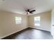 Cozy bedroom featuring wood-look flooring, neutral paint, and a modern ceiling fan at 4616 34Th E Ave, Bradenton, FL 34208