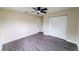 Spacious bedroom features modern gray floors, closet, and a door leading to other parts of the house at 4616 34Th E Ave, Bradenton, FL 34208
