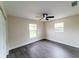 A bright bedroom features modern gray flooring and two windows at 4616 34Th E Ave, Bradenton, FL 34208