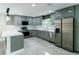Contemporary kitchen with stainless steel appliances, sleek gray cabinetry, and stone countertops at 4616 34Th E Ave, Bradenton, FL 34208