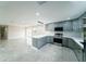 Modern kitchen featuring gray cabinets, stainless steel appliances, and an eat-in island at 4616 34Th E Ave, Bradenton, FL 34208