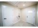 Laundry room with two doors and tile flooring at 4616 34Th E Ave, Bradenton, FL 34208