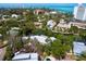 Stunning aerial view of a coastal home surrounded by a canal, showcasing its proximity to the water and beaches at 4830 Estrada De Costa, Sarasota, FL 34242