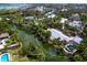 Aerial view of a waterfront property with a pool and lush surroundings at 4830 Estrada De Costa, Sarasota, FL 34242