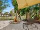 Comfortable seating by a serene backyard pond with a chiminea, offering a perfect spot for relaxation at 4830 Estrada De Costa, Sarasota, FL 34242