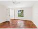 Bright bedroom featuring unique terracotta tile floors, white walls, and a view of the pond at 4830 Estrada De Costa, Sarasota, FL 34242