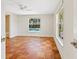 Bright bedroom featuring unique terracotta tile floors, white walls, and a view of the pool at 4830 Estrada De Costa, Sarasota, FL 34242