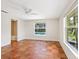 Bright bedroom featuring unique terracotta tile floors, white walls, and a view of the pool at 4830 Estrada De Costa, Sarasota, FL 34242