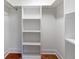 Walk-in closet with built-in shelving and terracotta tiled floors at 4830 Estrada De Costa, Sarasota, FL 34242