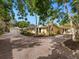 Expansive exterior view showcasing the home's layout with lush landscaping and a long driveway at 4830 Estrada De Costa, Sarasota, FL 34242