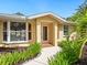 Inviting front entrance showcasing a well-manicured garden and a tiled front porch at 4830 Estrada De Costa, Sarasota, FL 34242