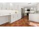 Kitchen featuring modern white cabinets, countertops, stainless steel appliances, and terracotta tile flooring at 4830 Estrada De Costa, Sarasota, FL 34242