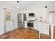 Bright, white kitchen with stainless steel appliances and terracotta tile floors at 4830 Estrada De Costa, Sarasota, FL 34242