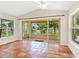 Bright living room featuring terracotta tile floors and sliding glass doors overlooking the water at 4830 Estrada De Costa, Sarasota, FL 34242
