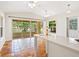 Living room featuring terracotta tile floors and bar area; view of screened-in porch and waterfront at 4830 Estrada De Costa, Sarasota, FL 34242