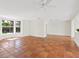 Bright living room features neutral paint, tile floors, a ceiling fan, and a large bay window at 4830 Estrada De Costa, Sarasota, FL 34242