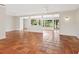 Open concept living room with tile floors, neutral paint, ceiling fans, and a view of the water at 4830 Estrada De Costa, Sarasota, FL 34242
