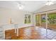 Living room with terracotta tile floors and bar area; view of screened-in porch and waterfront at 4830 Estrada De Costa, Sarasota, FL 34242