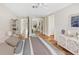 Spacious main bedroom with ample storage, and a view to an office space, featuring terracotta flooring at 4830 Estrada De Costa, Sarasota, FL 34242