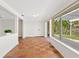 Bright sun room featuring tile floors, neutral paint, and floor-to-ceiling sliding glass doors at 4830 Estrada De Costa, Sarasota, FL 34242