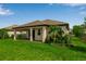 Beautiful backyard with a covered patio, lush landscaping, offering a peaceful outdoor living space at 4869 Antrim Dr, Sarasota, FL 34240
