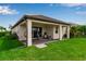 Picture of a manicured backyard featuring a covered patio and lush lawn at 4869 Antrim Dr, Sarasota, FL 34240