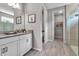 Bright bathroom featuring double sink vanity, walk in shower, and a convenient adjoining closet at 4869 Antrim Dr, Sarasota, FL 34240