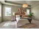 Stylish primary bedroom featuring wood-look floors, plantation shutters, and modern chandelier at 4869 Antrim Dr, Sarasota, FL 34240