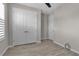 Neutral bedroom featuring wood-look tile floors, and double door closet at 4869 Antrim Dr, Sarasota, FL 34240