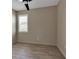 Bedroom featuring wood-look tile floors, plantation shutters, and ceiling fan at 4869 Antrim Dr, Sarasota, FL 34240