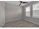 Inviting bedroom with ceiling fan, plantation shutters and wood look tile flooring at 4869 Antrim Dr, Sarasota, FL 34240
