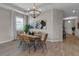 Dining room with modern lighting, a table with six chairs, and neutral decor at 4869 Antrim Dr, Sarasota, FL 34240