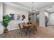 Dining area featuring modern lighting, a table with six chairs, and tile flooring at 4869 Antrim Dr, Sarasota, FL 34240