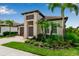 Beautiful two-story home featuring a tile roof, landscaped yard, and attached two-car garage at 4869 Antrim Dr, Sarasota, FL 34240