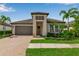 Charming one-story home boasts lush landscaping, paver driveway, and a welcoming entrance with a stylish front door at 4869 Antrim Dr, Sarasota, FL 34240