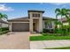 Charming one-story home boasts lush landscaping, paver driveway, and a welcoming entrance with a stylish front door at 4869 Antrim Dr, Sarasota, FL 34240
