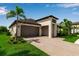 Beautiful single-story home with a paver driveway, two-car garage, and professionally landscaped front yard at 4869 Antrim Dr, Sarasota, FL 34240