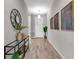 Hallway features wood-look flooring, console table with decor, and modern art at 4869 Antrim Dr, Sarasota, FL 34240