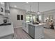 Open kitchen featuring an island with seating and stainless steel appliances with seamless flow to the living area at 4869 Antrim Dr, Sarasota, FL 34240