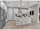 Well-lit kitchen featuring white cabinetry, stainless steel appliances, and an island with a breakfast bar at 4869 Antrim Dr, Sarasota, FL 34240