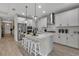 Bright kitchen featuring an island with barstool seating, sleek pendant lighting, and stainless steel appliances at 4869 Antrim Dr, Sarasota, FL 34240